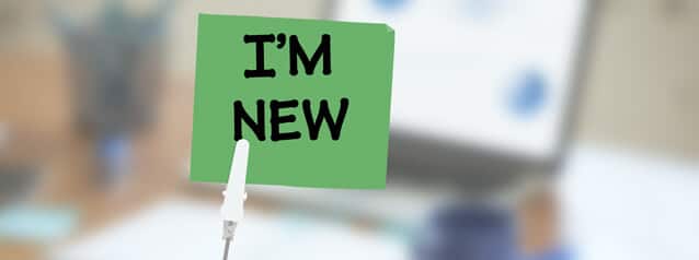 A green sticky note with "I'M NEW" represents fresh ideas in ITSM, secured by a clip against a blurred office backdrop. - SysAid