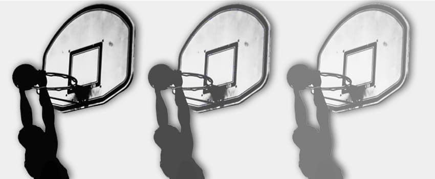 Silhouette of a basketball player dunking thrice, showcasing precision akin to SysAid's ITSM process efficiency. - SysAid