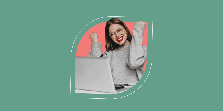 A smiling professional celebrates successful ITSM self-service, raising fists joyfully near a laptop in a vibrant setting. - SysAid