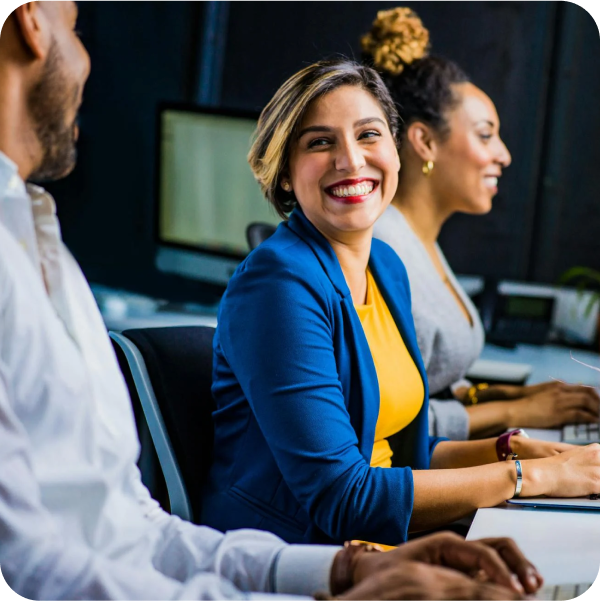 Three IT professionals collaborate at their service desk, using SysAid ITSM to manage and resolve support tickets efficiently. - SysAid