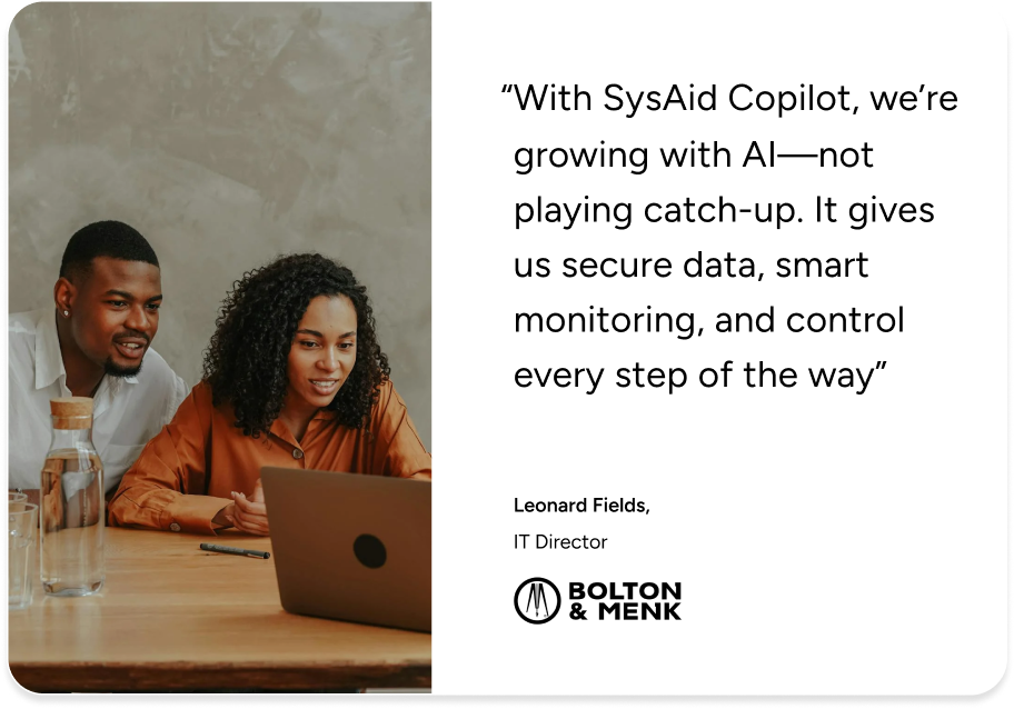 Two professionals review a SysAid Copilot testimonial on a laptop, highlighting Service Desk efficiency for Bolton & Menk. - SysAid