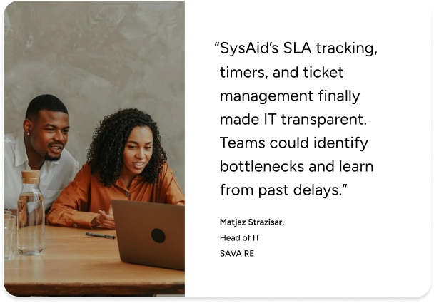 Two people collaborate at a desk, reviewing SysAid’s ITSM benefits highlighted in a customer testimonial. - SysAid