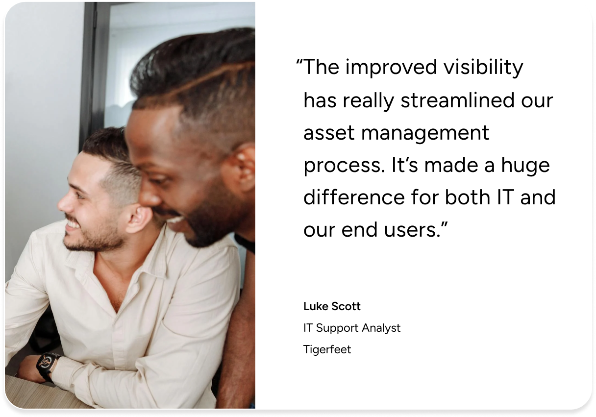 Two people smiling at a computer, highlighting ITAM success with SysAid ITSM—testimonial from Tigerfeet’s IT Support Analyst. - SysAid