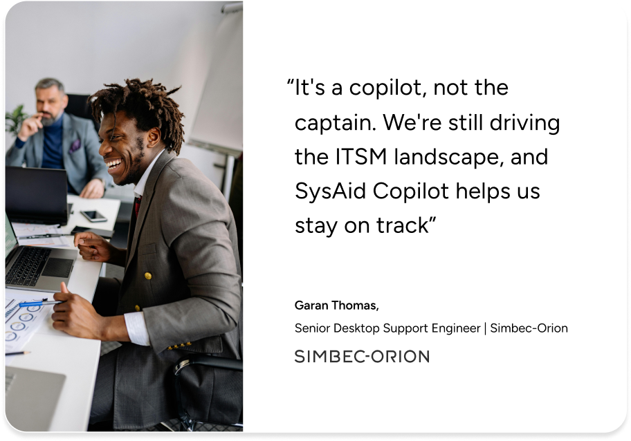 ITSM professional smiling at desk with laptop, highlighting SysAid Copilot’s impact per Simbec-Orion IT support expert. - SysAid