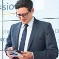 ITSM professional using a tablet to manage service desk tasks, highlighting SysAid’s ITSM solutions in an office setting. - SysAid