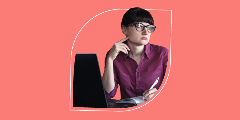 Individual in pink shirt, focused at laptop with pen, embodies SysAid's ITSM efficiency—streamlining your Help Desk tasks. - SysAid