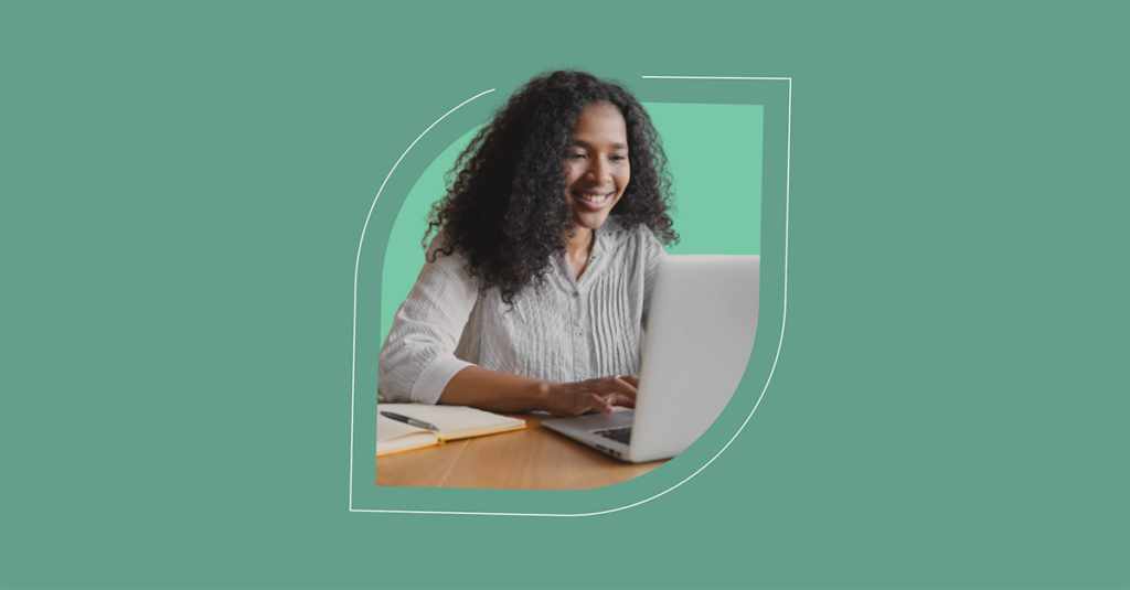 Woman smiling while using laptop on ITSM platform in 2022, ready to innovate. Green leaf design background adds natural touch. - SysAid