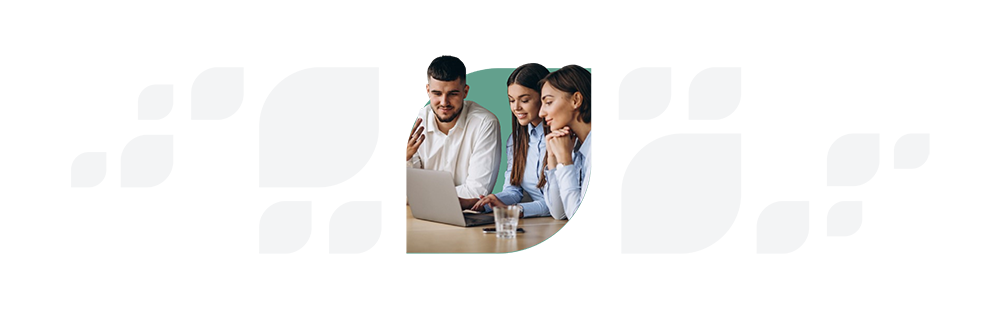 Three professionals collaborating around a laptop in an office setting.